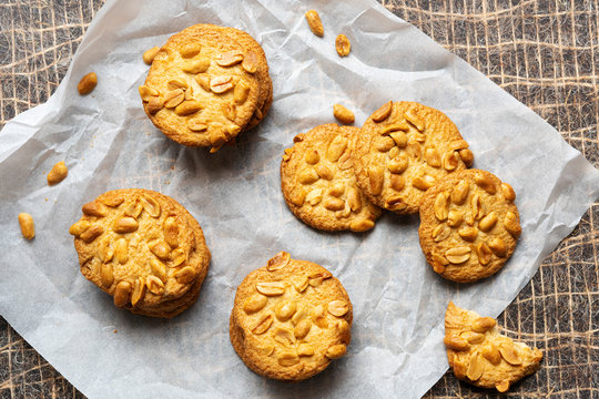 Three stacks of peanut cookies on baking paper.