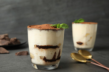 Delicious tiramisu cake in glass on table