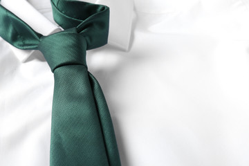 Color male necktie on white shirt, closeup. Space for text