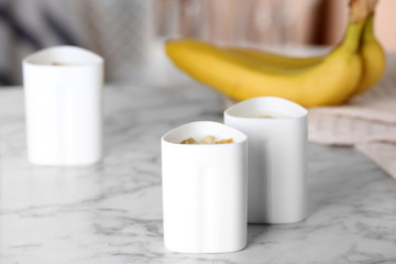 Cups of yogurt with bananas on table. Multi cooker recipe