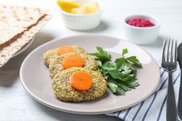 Plate of traditional Passover (Pesach) gefilte fish on wooden table