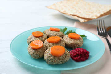 Plate of traditional Passover (Pesach) gefilte fish on wooden table