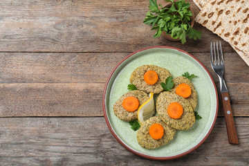 Flat lay composition with plate of traditional Passover (Pesach) gefilte fish  on wooden...