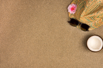 Fototapeta na wymiar Minimalist summer flat lay with, sunglasses and panama hat on sand background