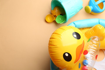 Flat lay composition with bright beach toys on color background. Space for text