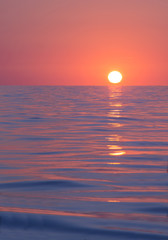 Sun rises beyond horizon