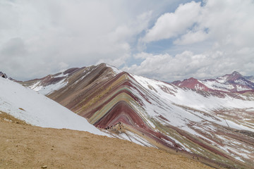 View of the incredible rainbow mountains outside of Cusco, Peru. The quantities are a variety of colors of mineral deposits in the soil