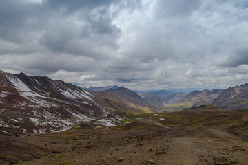 View of the incredible rainbow mountains outside of Cusco, Peru. The quantities are a variety of colors of mineral deposits in the soil