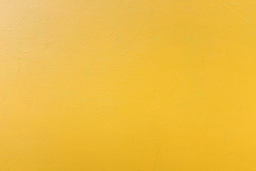 Full frame view of yellow painted concrete wall - background concept