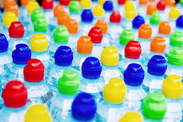 Colored stoppers of new plastic bottles, concept of pollution by recyclable plastics.