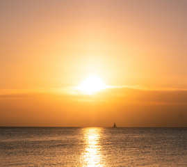 Naklejka na ściany i meble Ocean sunset sailboat