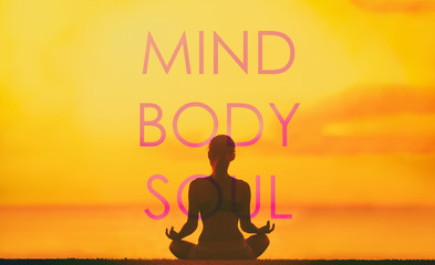 Yoga poster with title written MIND BODY SOUL in big on sunset background with silhouette of girl...