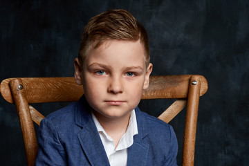 schoolboy portrait on dark background close up