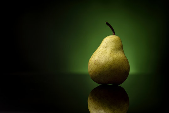 tasty juicy pear on green background proper diet