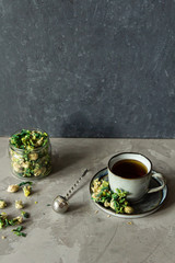 Obraz na płótnie Canvas Brewed delicious herbal tea on a wooden on background