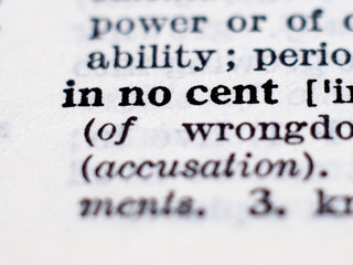 Dictionary definition of word innocent. Selective focus.