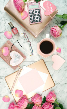 Ultra Feminine Pink Desk Workspace With Rose Gold Accessories On White Marble Background Flatlay Overhead.