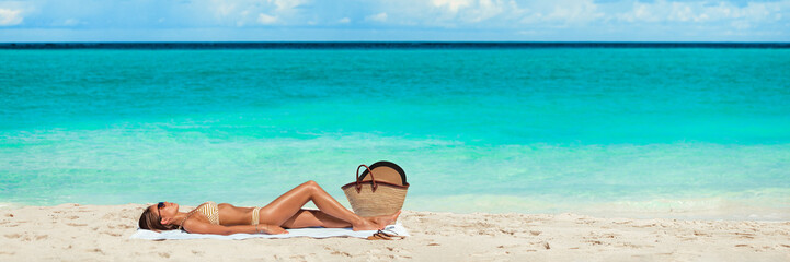 Beach vacation suntan woman banner panorama summer travel sunbathing girl relaxing on blue ocean...