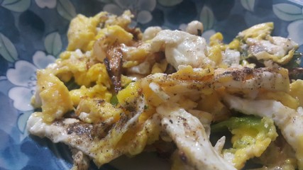 Closeup view of fried egg omelet dish in a fry pan.