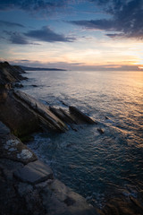 scenic view with sunset on atlantic ocean with rocks in socoa, basque country, france