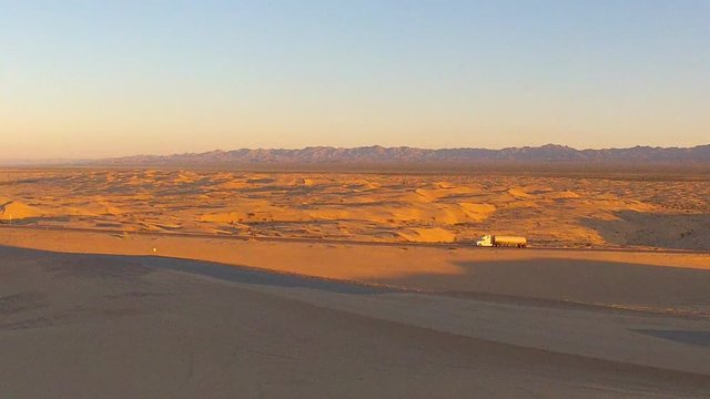 Distant Big Rig Truck On Highway Through Algodones Sand Dunes