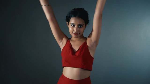 Young Indian female sensually dancing a traditional dance.
