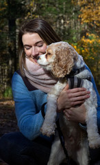 Young woman holding her dog