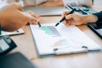 Business people analyzing investment graph meeting brainstorming and discussing plan in meeting room, investment concept