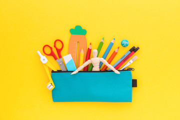 Pencil case and stationery, Creative flat lay on yellow background.