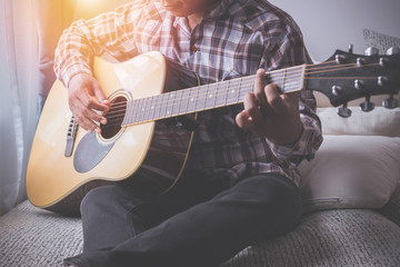 Fototapeta premium singer playing guitar on bed.