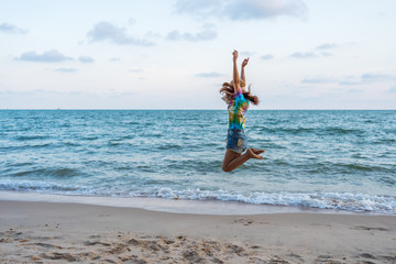 woman enjoy and jumping on sea beach