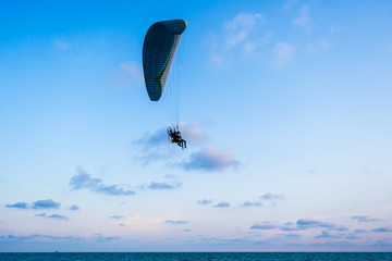paraglider flying on sea and sky