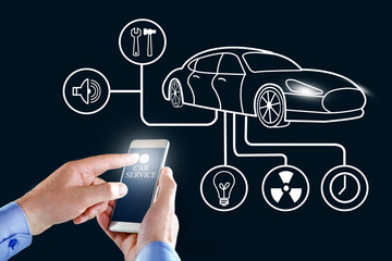 Smartphone application to control the smart car by internet. Car monitoring system. Hand holding...