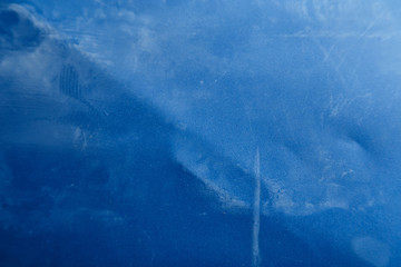Bright abstract dirty blue texture with scratches and scuffs