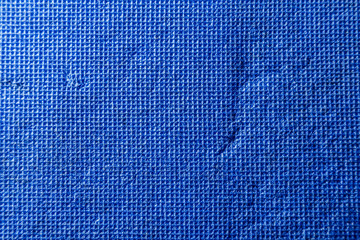 Bright blue texture consisting of small squares with scratches and scuffs