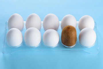 Kiwi in a plastic box with white eggs.Creative idea for a beauty salon advertisement, Laser epilation, Hair removal and cosmetology at cosmetic beauty spa clinic.