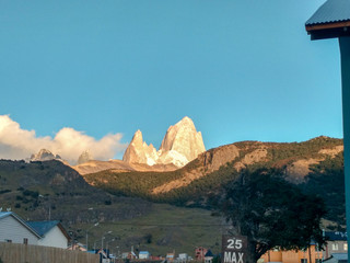 The Mount Fitz Roy in the gold hour over the blue sky