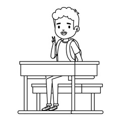 happy little student boy seated in school desk