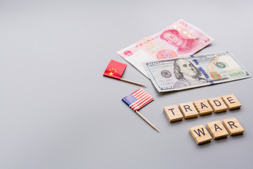 Creative top view flat lay of China and USA flags and cash money, mockup and copy space on gray background in minimal style. Concept of trade war between USA and China