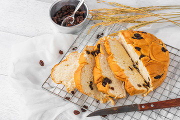 sliced raisin bread on white wooden table background