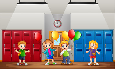 Funny children holding a balloons in front the class
