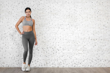 Sport woman in sportswear relax stand after workout against copy space for adding text with white wall background.Diet concept.Fitness and healthy lifestyle