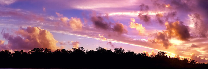 Golden colored tropical sunset cloudscape.
