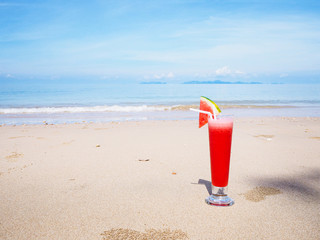  glass of watermelon juice on summer beach
