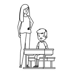 student boy seated in school desk with female teacher