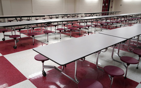 tables and seats inside high school cafeteria