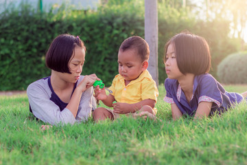 .The sisters and brothers are playing with fun. Asian children are happy. At the park in Thailand