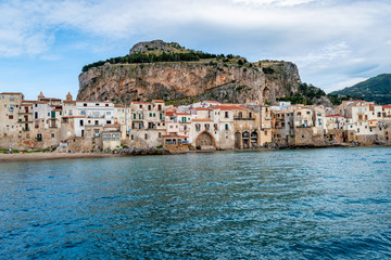 Fototapeta na wymiar Cefalu, Province of Palermo, Sicily, Italy - Looking to the blue sea, medieval buildings and La Rocca