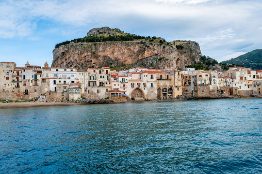Cefalu, Province of Palermo, Sicily, Italy - Looking to the blue sea, medieval buildings and La Rocca