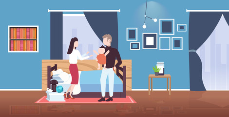 father mother and newborn baby having fun together happy family parenthood concept man woman playing with newborn child modern bedroom interior flat full length horizontal